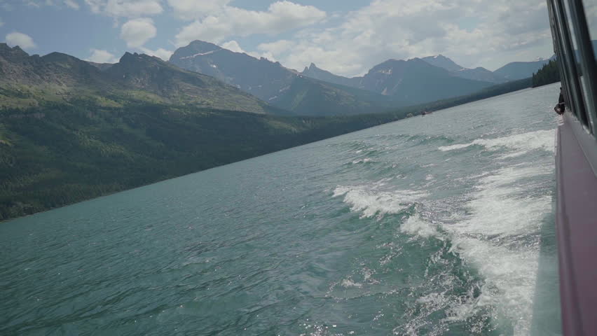 View of a glacial peak from a ferry on a lake in Glaciers National Park, Montana USA.