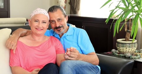 Portrait of a happy sick woman fight with cancer with family's help