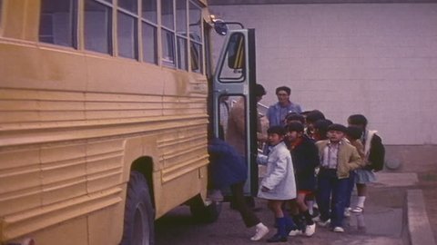 CIRCA 1970s - Navajo children ride a school bus.
