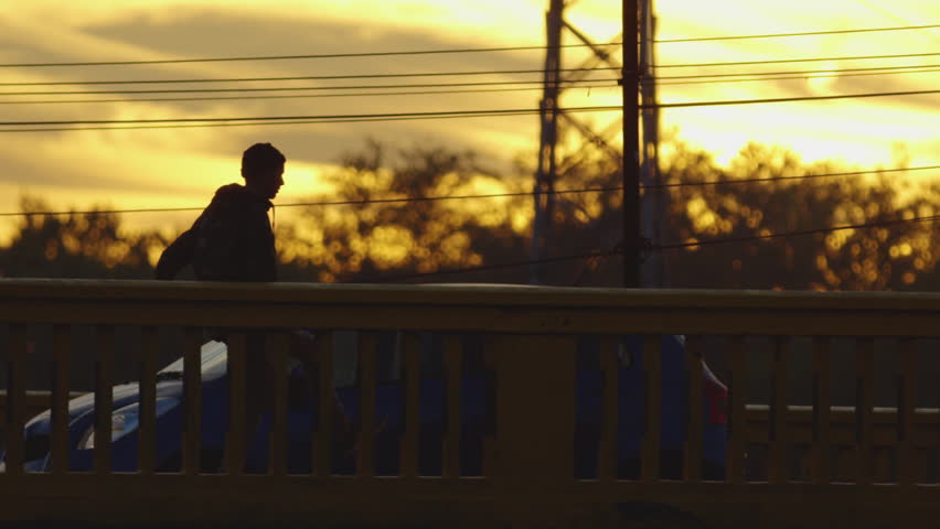 Skateboarding on a bridge in the evening. | Shutterstock HD Video #1013743571