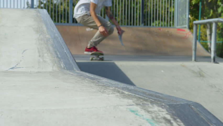 View of a skater doing a Crooked Grind trick. | Shutterstock HD Video #1013743670