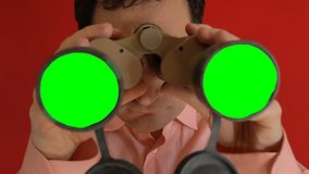 A funny ugly man looking through a pair of military binoculars, the lenses are green (replace with your footage using chroma-key). Close-up shot.
 - Powered by Shutterstock - Get 15% off with code: PIKWIZARD15