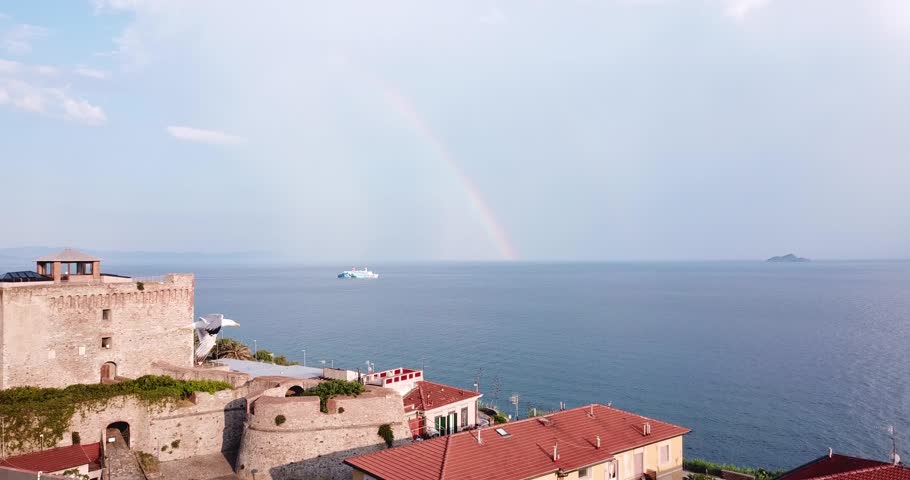 Piombino, Toscana, Italy. Aerial view of the city, sea, ship and rainbow at the sky