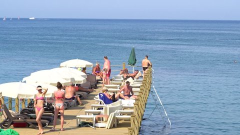 Happy Womans Calling For Her Summer Season, Cheerful Girl Standing On Wooden Pier. June 7, 2018 - Antalya Turkey