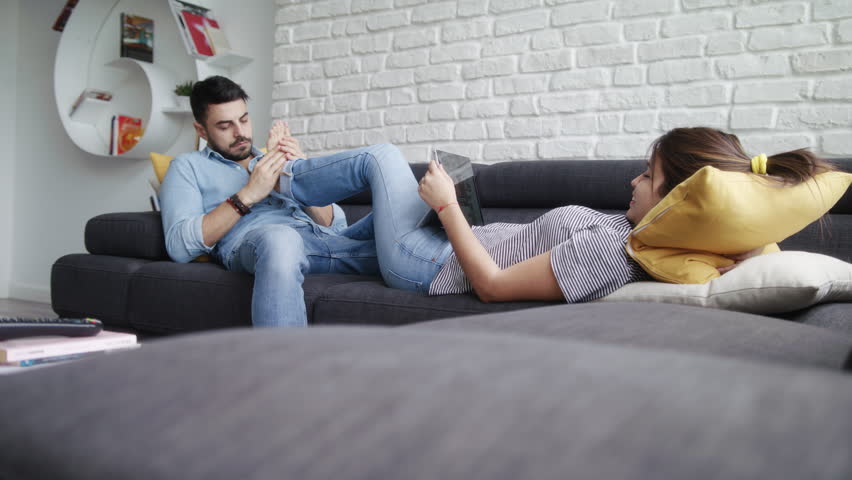 Young Hispanic Couple Laying On Couch Stock Footage Video 100 Royalty Free 1013756762 3435