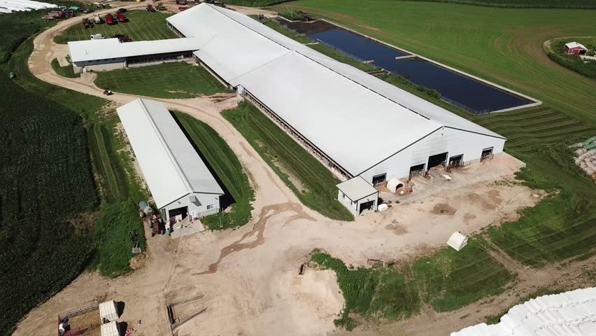 Milk truck arriving during flyover of mid-west farm. Filmed on Wisconsin dairy farm near Mt Horeb.