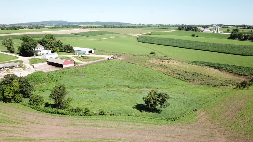Farmhouse on beautiful mid-west landscape, high stationary shot. Filmed on Wisconsin dairy farm near Mt Horeb.