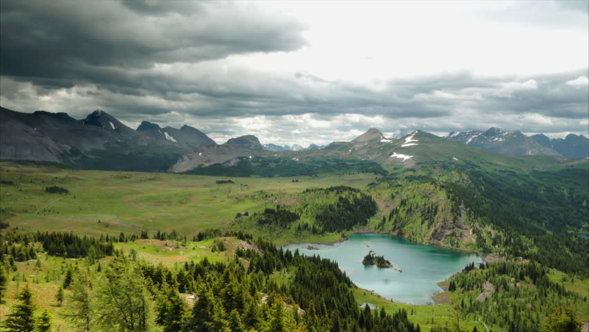Timelapse of Rocky Mountain storm clouds over tourquise alpine lake