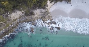 Drone Video of Waves Rolling in with Clear Blue Ocean and White Sand in Tasmania