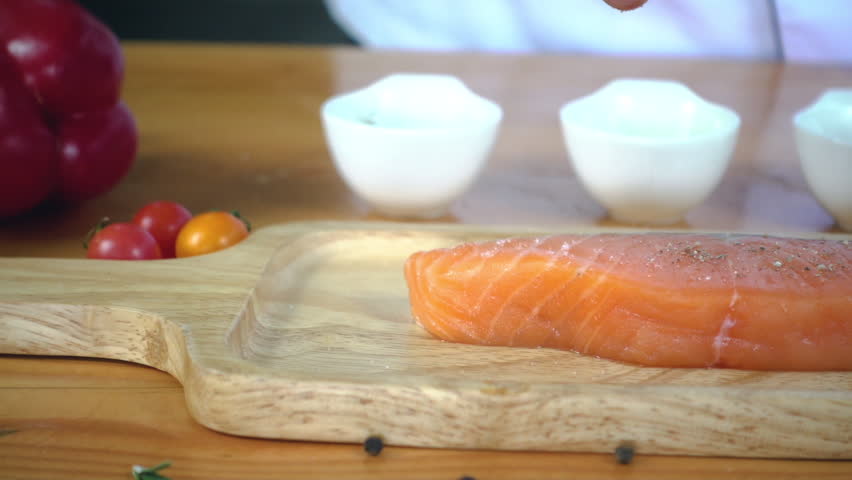 Close-up 4K slow-motion video of salmon sushi making. The sauce is