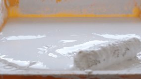 Roller sinking in white paint slow-mo  footage