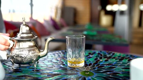 Enjoying the local custom of mint tea at a cafe in the Medina section of Marrakech, Morocco.