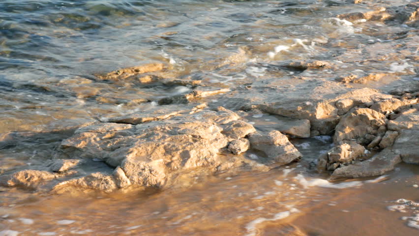 turquoise sea water waves and stones - timelapse