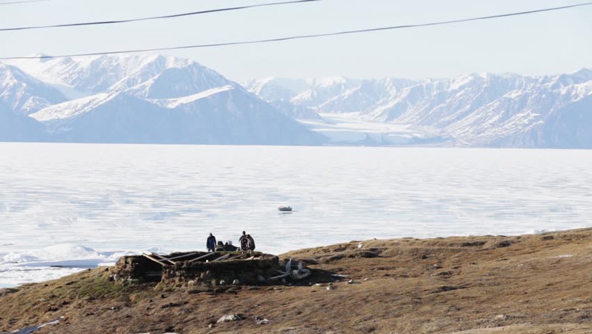 People trying to Fix an ATV, Pond Inlet Nunavut