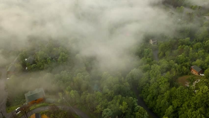 Aerial drone shot on top of clouds looking down at nature. | Shutterstock HD Video #1013780612