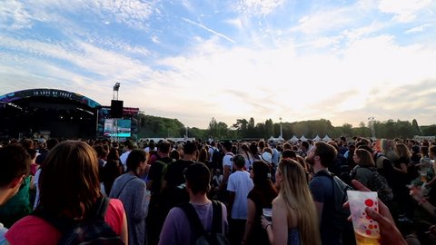 Paris, France - 06 22 2018: outdoor music festival crowd of people dancing during sunset, Solidays 2018