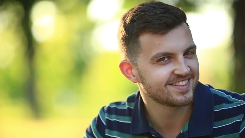 Young loving couple dating while riding bicycles in the park