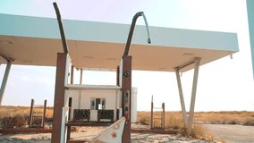 Old dirty deserted gas station. U.S. Route 66. crisis lifestyle road 66 fueling slow motion video. closed supermarket store shop Abandoned gas station oil end of fuel the world apocalypse petrol. main