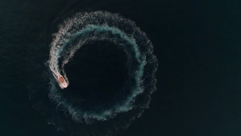 Aerial yacht boat spinning and making circle waves at sea in Monaco, Monte Carlo