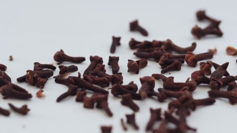 Falling on the white surface of cloves. Video footage of falling little cloves.