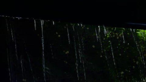 Heavy raining in tropical country ,water from roof dropping down ,low angle view. Raindrops from roof 