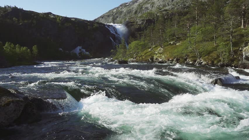 Rapid Stunning Waterfall in Husedalen Valley, Norway. Summer time. Nyastølsfossen