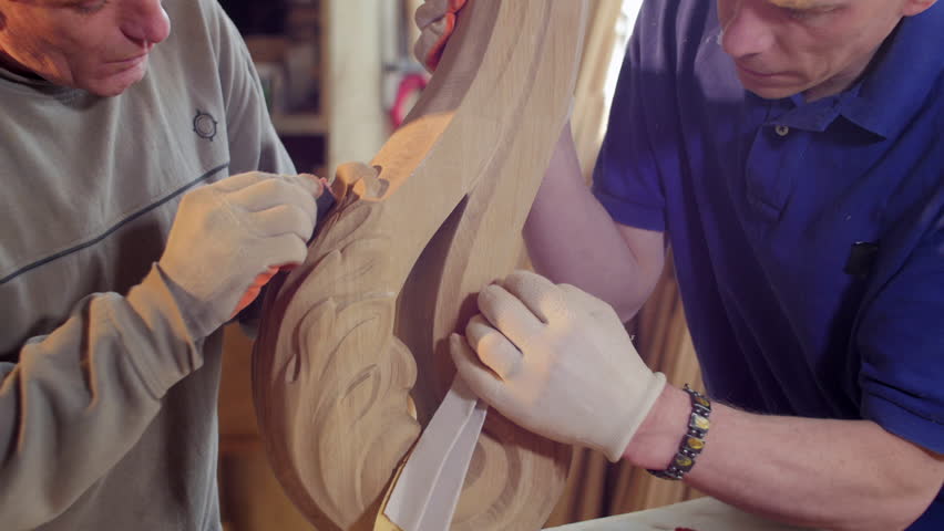Men sanding a wooden decoration | Shutterstock HD Video #1013809277
