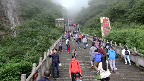 DAYONG, - OCTOBER 06:
Chinese tourists at the  stairway leading to top of Tianmen Mountain with the Natural arch..
October 06, 2017 in Dayong, Hunan, China