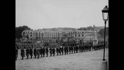 CIRCA 1919 - Soldiers march and cars drive up to the Palace of Versailles for the Paris Peace Conference.