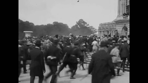 CIRCA 1919 - Crowds cheer for President Wilson, Lloyd George, and Premiers Clemenceau and Orlando outside the Palace of Versailles.