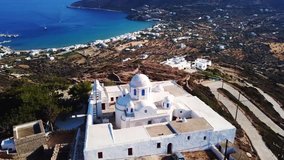 Aerial drone bird's eye view video from famous monastery of Panagia Vouno overlooking bay of Platy Yalos, Sifnos island, Cyclades, Greece