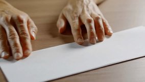 adult human is folding paper sheet in half and bending corners to center, making of origami figure - Powered by Shutterstock - Get 15% off with code: PIKWIZARD15