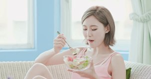 beauty woman eat salad and feel enjoy at home