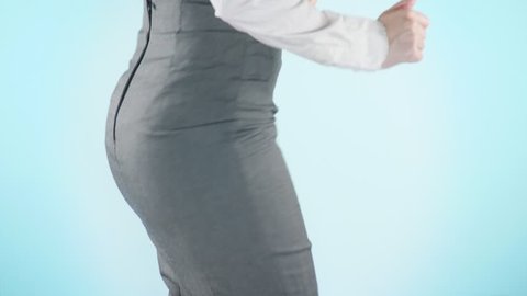Beautiful business woman on a colored background. close-up skirt. dress code, move the hips. 4k, slow motion