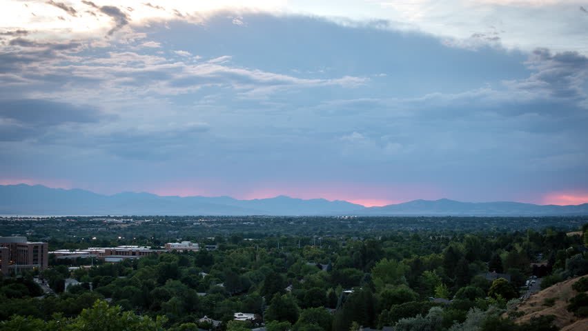Time lapse of colorful sunset lighting up the horizon over Utah Valley viewed from Provo.
