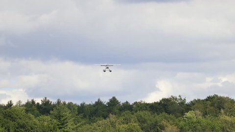 A float Plane comes in for a water landing on a small Canadian Lake.