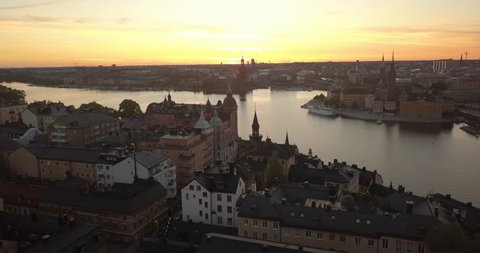 Aerial view of Stockholm Sweden during the golden hour. The dronees forward flying close to a tower. Majestic colours in the sky.