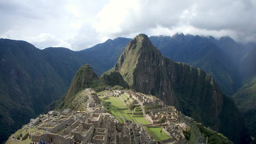 Timelapse - BEAUTIFUL shot of Macchu Pichu Ruins in Peru on a sunny day, with dozens of tourists moving through the Ruins