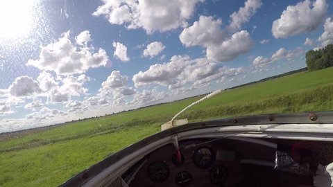 Clip of the landing of a glider in a field.