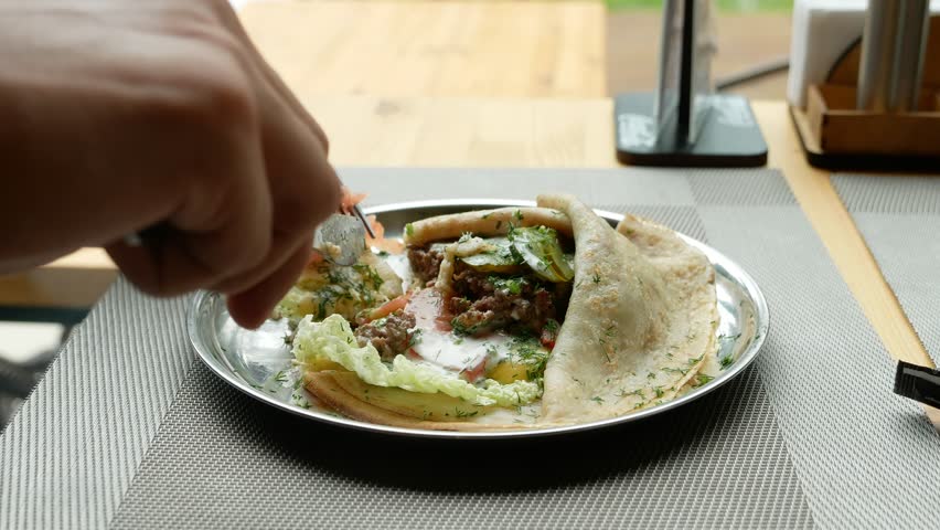 people eat stuffed pancakes in a cafe. 4k, slow motion.