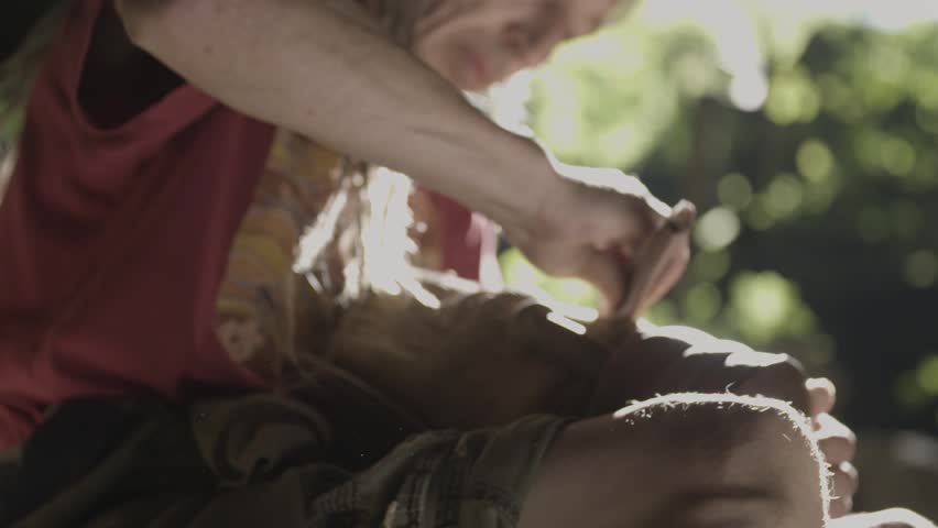 Elderly men is polishing  wood in a cave.
