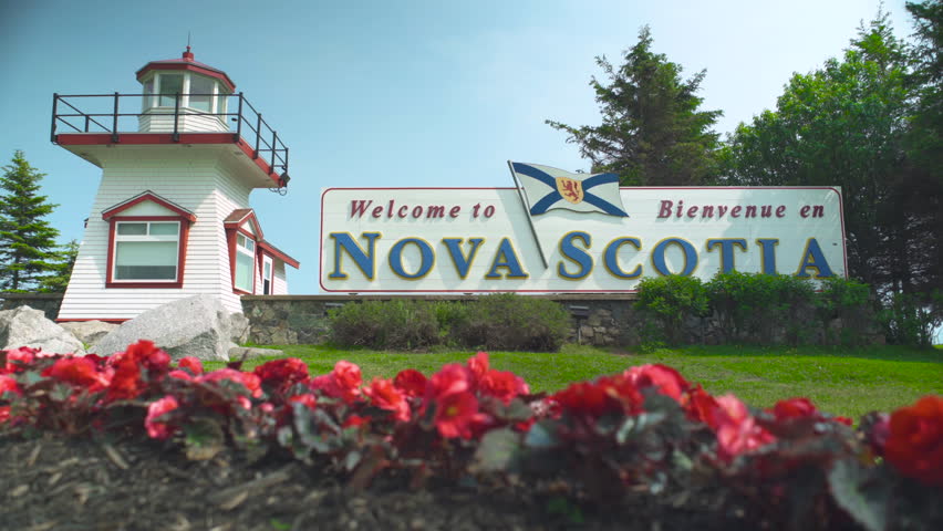 Welcome to Nova Scotia sign with flower bed in foreground