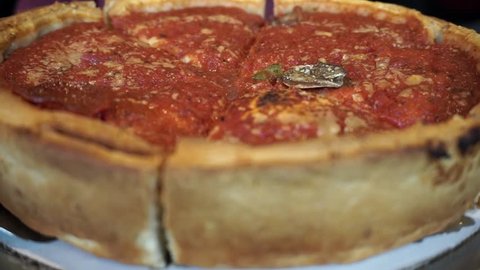 Shallow depth of field, closeup shot of a Delicious, Buttery, Cheesy Deep Dish Pizza!