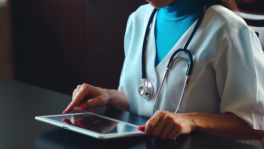 Woman doctor using tablet computer in hospital Royalty-Free Stock Footage #1013856317