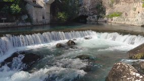 Small village Blagaj on Buna spring and waterfall, the video ends on a large rocky mountain