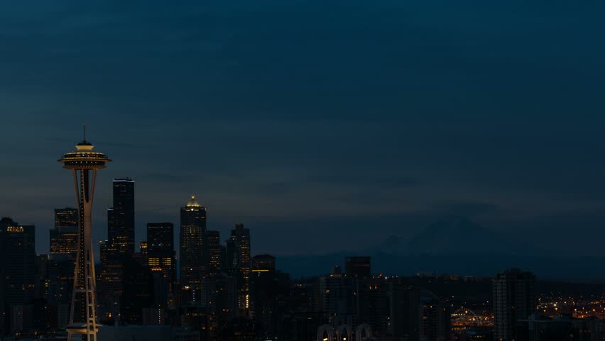 Ultra high definition 4k time lapse movie of  moving clouds and sky over downtown urban cityscape in Seattle WA from early morning dawn sunrise into daylight 4096x2304 uhd