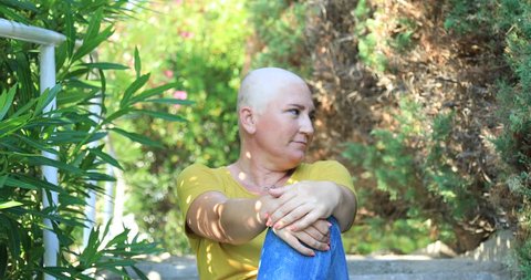 Portrait of asmiling  woman with cancer sitting at the outdoor