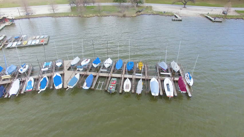 Boats at a dock on a lake during a windy day in Texas.