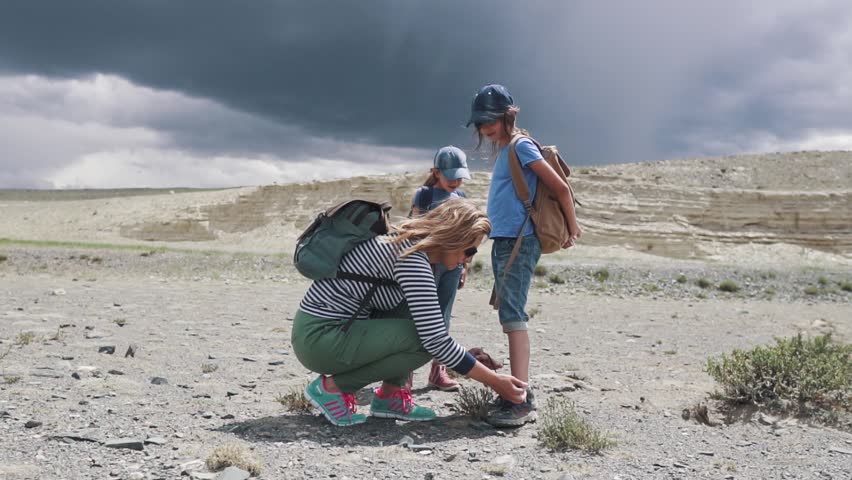 the mother ties up the laces to the child in the campaign