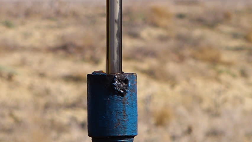 A shot of an oil pump, pumping oil from the ground.